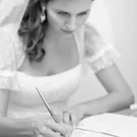Young bride signing wedding documents
