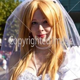 colorful girl made up as Bride  and poses for photografers